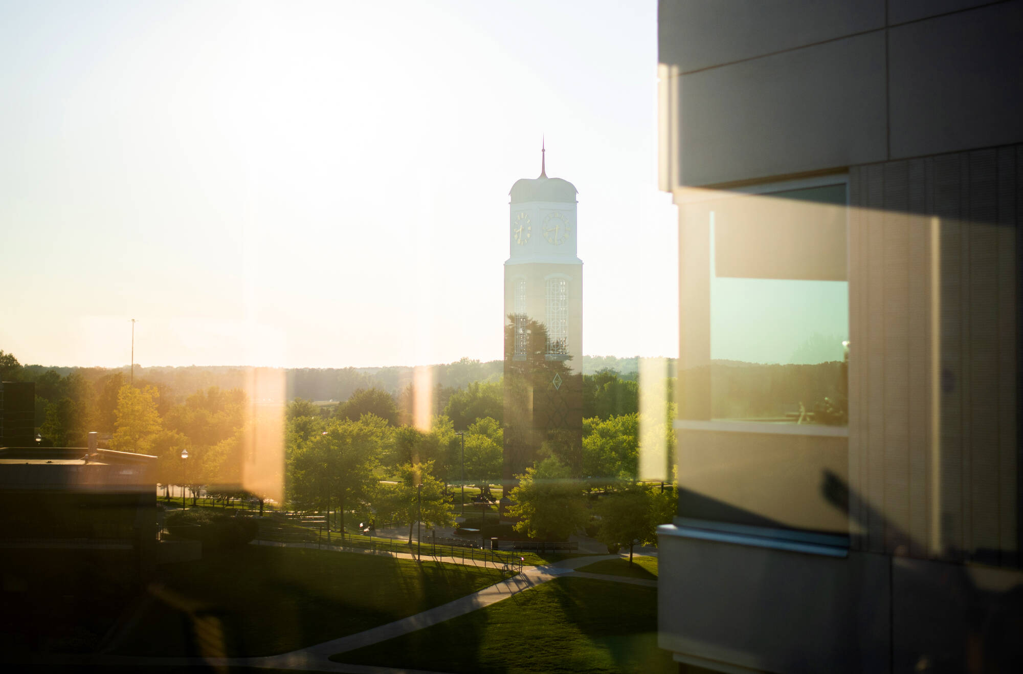 Photo taken through a window showing the Carillon tower
